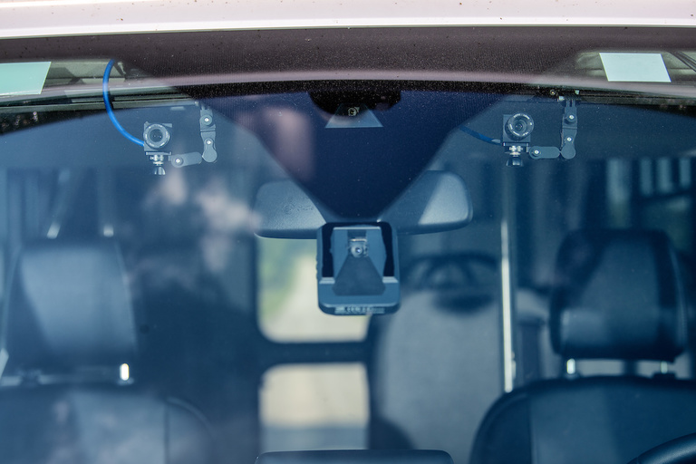 View of front windshield showing an interior webcam and Mobileye collision avoidance system